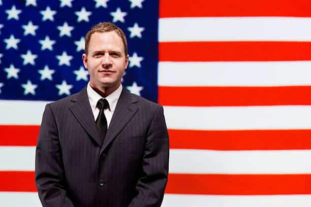 istock Businessman standing in front of American flag 478662499