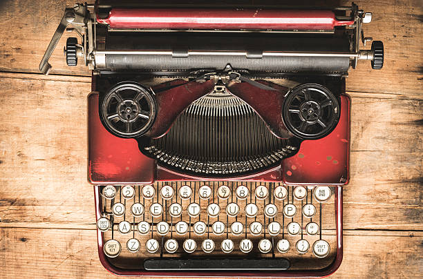 istock Vintage Red Portable  Typewriter on a Rustic Wood Background 478667600