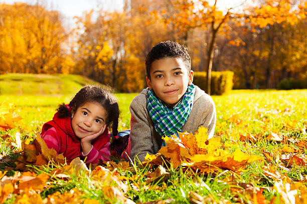 istock Brother and sister on autumn lawn 478667939