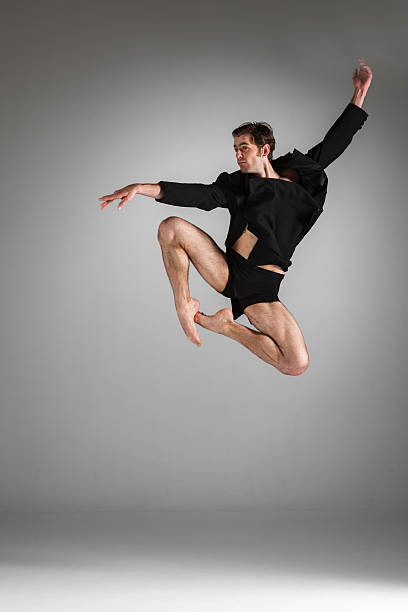 istock The young attractive modern ballet dancer jumping on white background 478668998