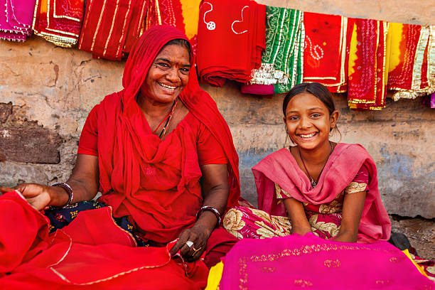 Indian women selling colorful fabrics