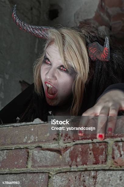Scary Hungry Female Demon Crawling Over Old Dirty Brick Wall Stock Photo - Download Image Now