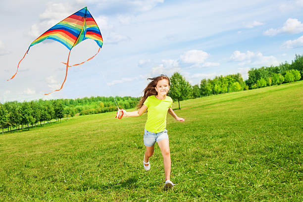 istock 6 years old girl running with kite 478670223