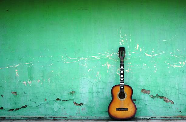 Spanish guitar on old green wall Spanish guitar on old green wall, copy spaced. flamenco photos stock pictures, royalty-free photos & images