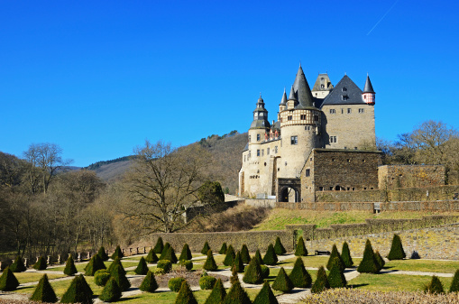 Mayen, Germany - March 9, 2014: Castle and Palace Burresheim on small hill behind little palace garden.