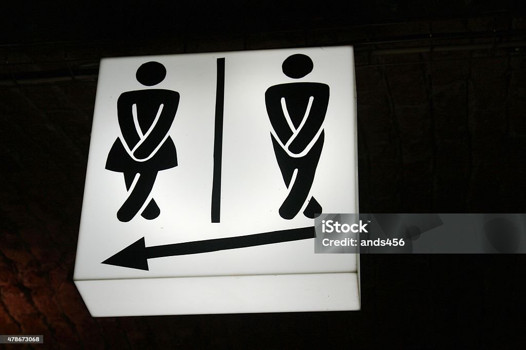 humorous  sign indicating male and female toilet facilities Restroom Sign Stock Photo