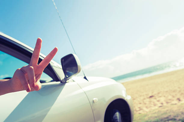 istock Woman making a peace sign while driving 478677715