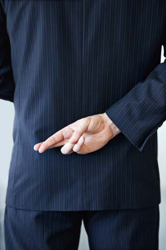 Cropped shot of a businessman crossing his fingers behind his back