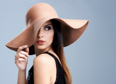 cheerful woman with a red cap on his head glamor isolated background. High quality photo