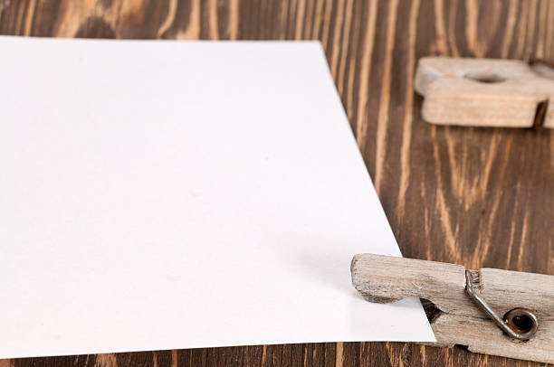 istock Old wooden clothes pins and blank paper 478680522