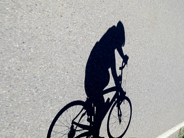 istock Shadow of a road biker speeding along in competition 478682002