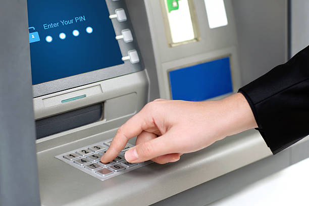 istock man enters PIN code and withdraws money from an ATM 478685505