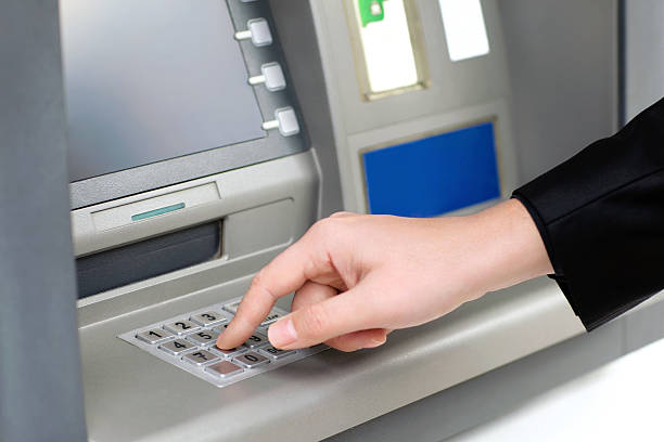 istock man enters PIN code and withdraws money from an ATM 478685507