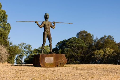 Perth, Australia - March 5, 2014: Yagan statue on Heirisson Island in Perth. The statue was Erected in 1984 to commemorate the Aboriginal warrior Yagan. Yagan was killed in 1833 by a British settler after a series of burglaries and robberies led to a bounty for his capture, dead or alive.
