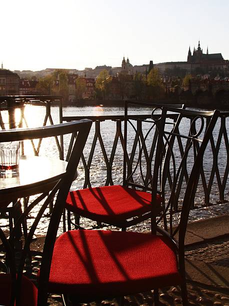 istock wrought iron table and chairs at river edge, Prague 478686722