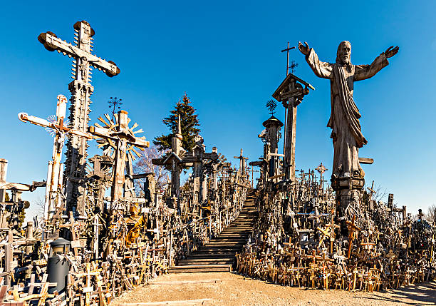 Hill of the Crosses near Siauliai city in Lithuania On this public hill giant crucifixes, carvings of Lithuanian patriots, statues of the Virgin Mary and hundred of thousands of different big and tiny effigies and rosaries have been brought here by Catholic pilgrims lithuania stock pictures, royalty-free photos & images