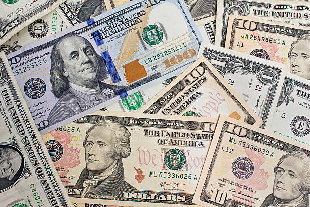 istock Close up of several dollar bills chaotically aligned 478690316