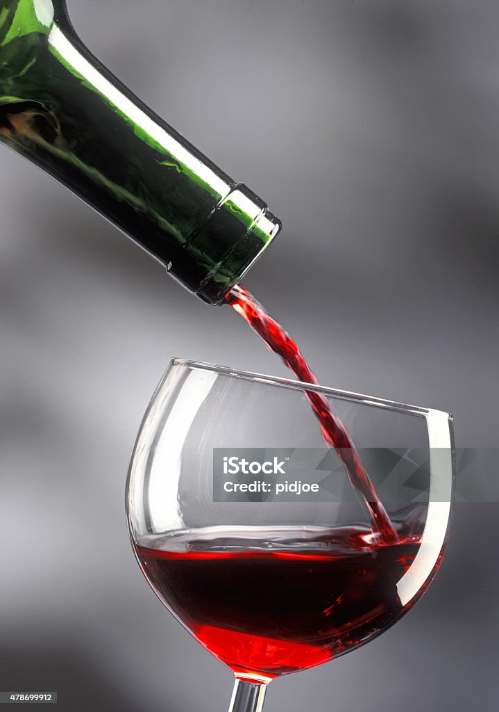 pouring a glass of red wine close up on pouring a glass of red wine on gray background Wine Tasting Stock Photo