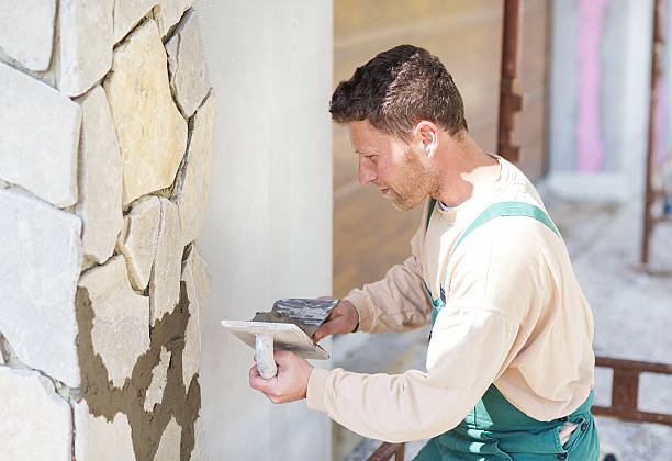 istock Man putting natural stones on a wall 478700182