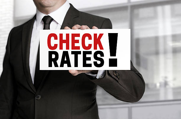 istock Check Rates sign is held by businessman 478704048