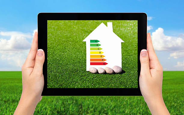 istock female hands holding tablet with house and sign energy saving 478704559