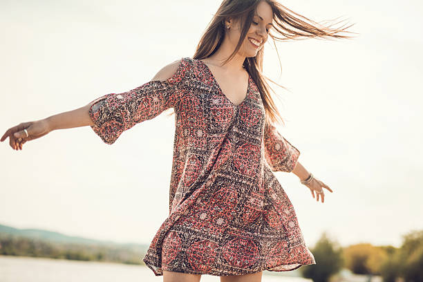 istock Carefree young woman spinning outdoors and having fun. 478704830