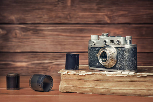 istock Vintage camera on old book over wooden background 478707560