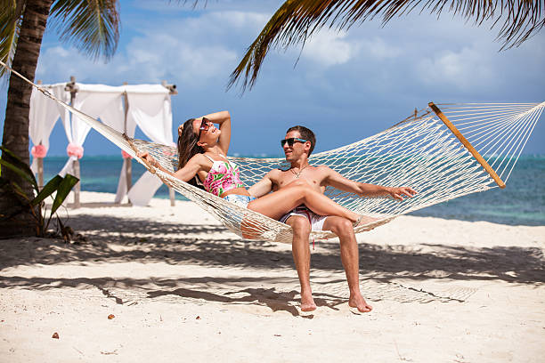 istock Romantic Couple Relaxing In Beach Hammock 478709188