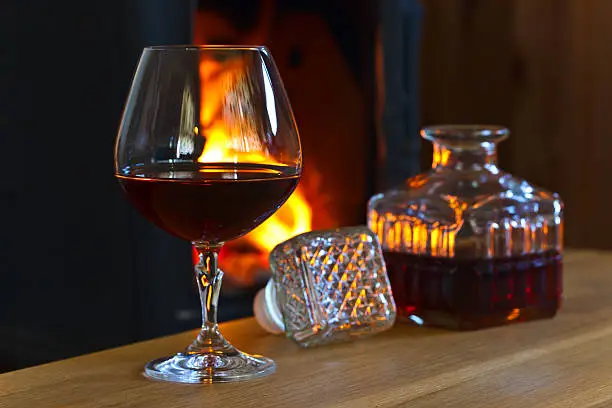 glass with brandy on a wooden table