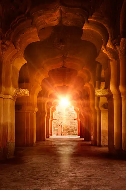 Old ruined arch in ancient palace at sunset, India