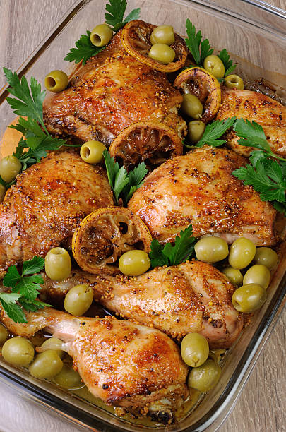 parts of chicken baked with lemon stock photo