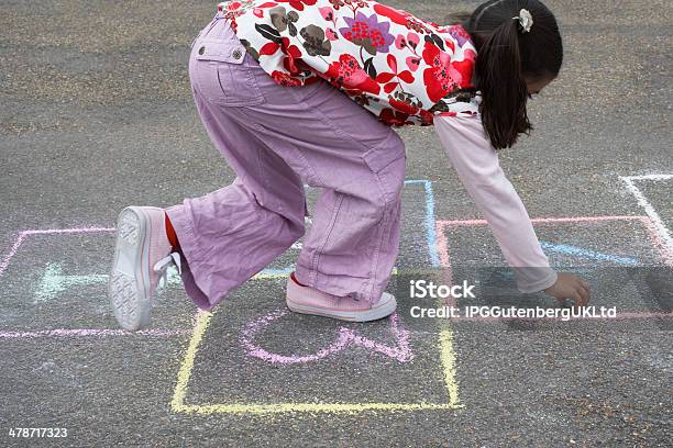 Girl Playing Hopscotch In Playground Stock Photo - Download Image Now - Balance, Casual Clothing, Child