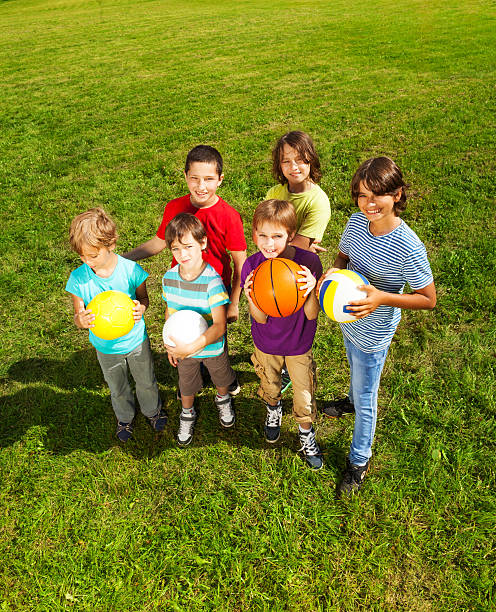 istock Boys with balls in the grass 478717779