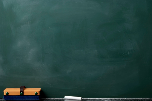 Close-up of blank blackboard with board eraser.