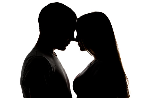 Silhouette of loving teenagers on white background