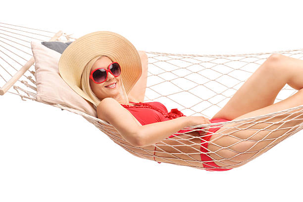 istock Beautiful blond woman lying in a hammock 478718880
