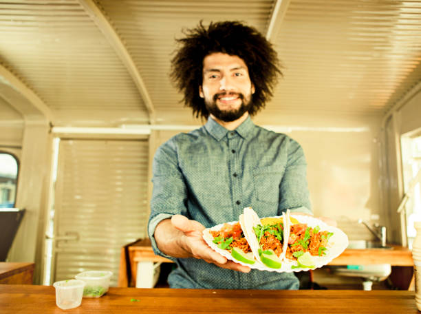 Food truck owner showing tacos