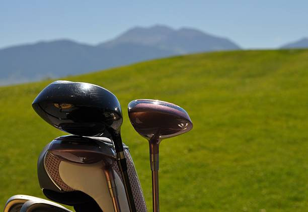 istock Golf Clubs on Hilly Course with Mountain Range Background 478720540