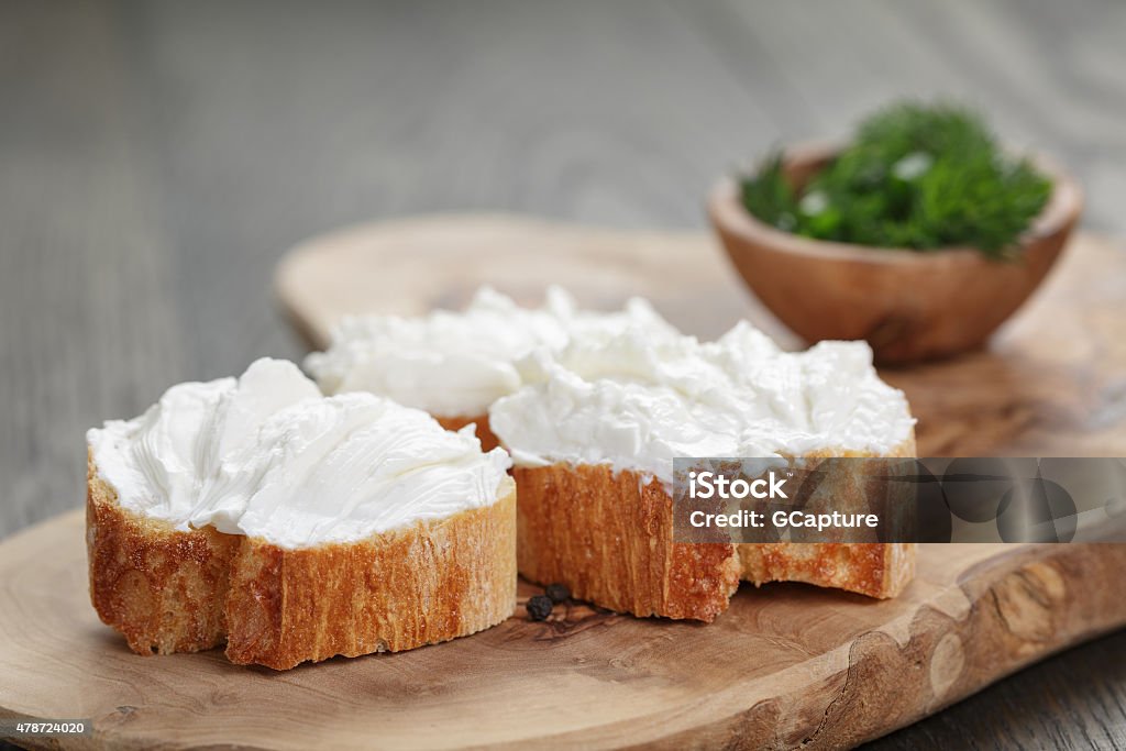 homemade appetizing crostini with soft cheese cream herbs homemade appetizing crostini with soft cheese cream and herbs, shallow focus Cream Cheese Stock Photo