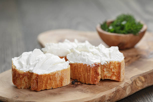 homemade appetizing crostini with soft cheese cream herbs homemade appetizing crostini with soft cheese cream and herbs, shallow focus cream cheese photos stock pictures, royalty-free photos & images