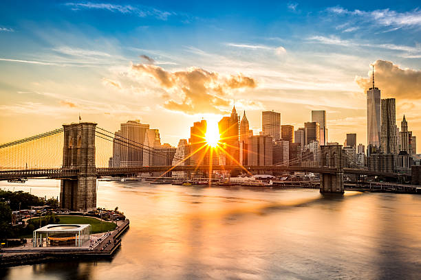 Brooklyn Bridge and the Lower Manhattan skyline at sunset stock photo