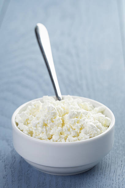 istock cottage cheese in white bowl on blue wooden table 478724308
