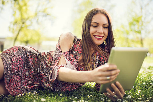 istock Happy woman using digital tablet at the park. 478724828