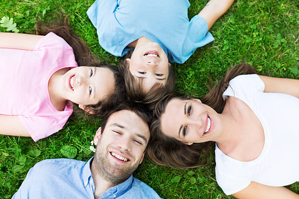 istock Family lying on grass smiling 478725130