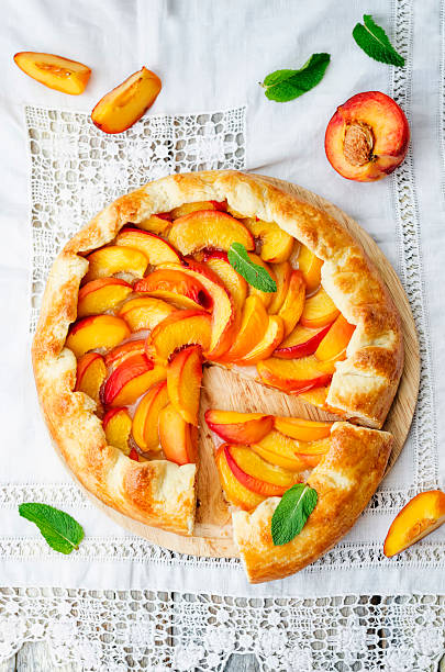 Crostata with peaches Galette with peaches on a white background. the toning. selective focus crostata stock pictures, royalty-free photos & images