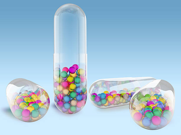 Capsule with colored balls stock photo