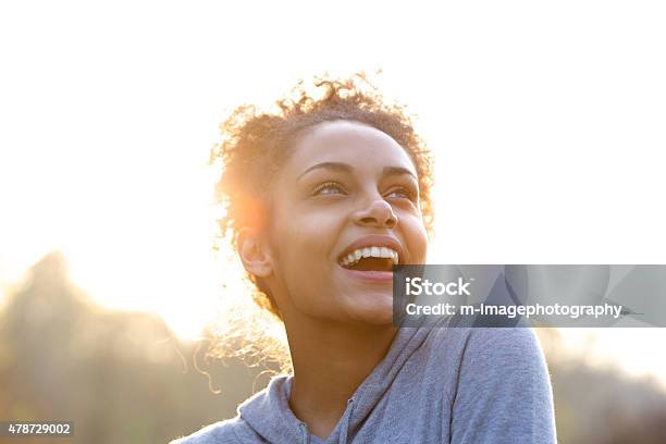 Attractive young woman laughing and looking up