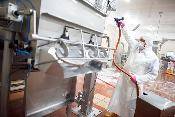 man washing machines at a factory - food hygiene imagens e fotografias de stock
