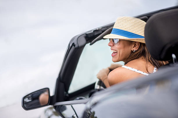 istock Happy summer woman driving a car 478730328