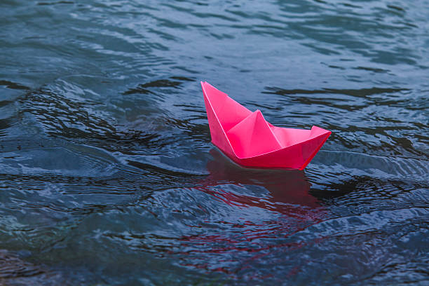 Pink boat floating in the blue water